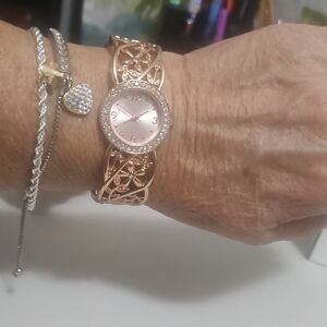 Rose Gold Filigree Watch Opens Closes With Springs Stones Around Face.